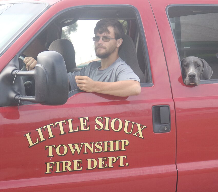 Little Sioux Volunteer Fire Dept. Trevor Collison, wiht Lola, at the Little Sioux Homecoming Parade.