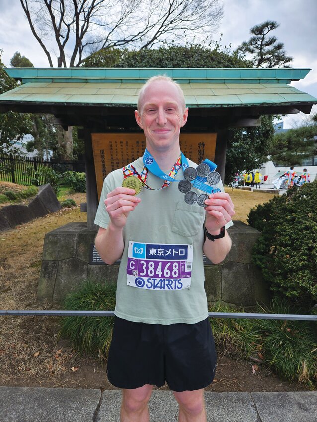 Carter Oliver poses with the Tokyo Medal and 6 Star Finisher Medal for completing the six Major Marathons.