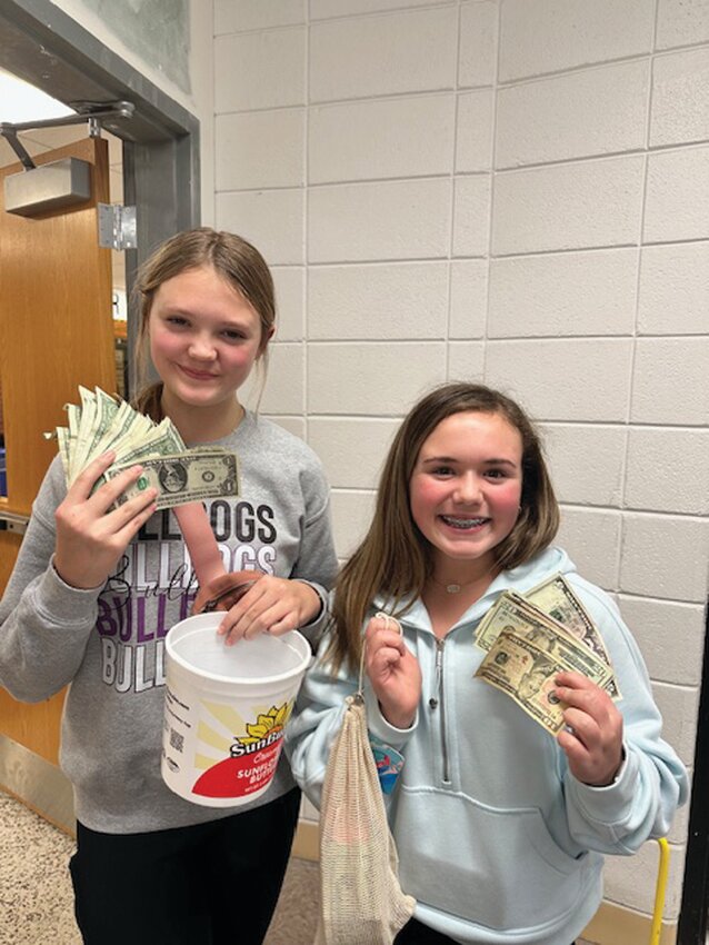 Dumbaugh (left) and Christiansen (right) smile after counting some of the money raised during the Jan. 19 fundraiser.