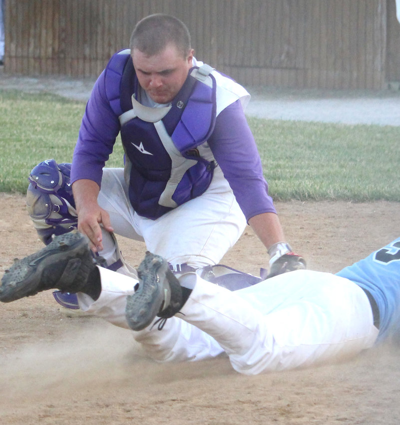 Logan-Magnolia's Barret Pitt slaps the tag on the baserunner in Tuesday's Western Iowa Conference home opener for the Panthers.