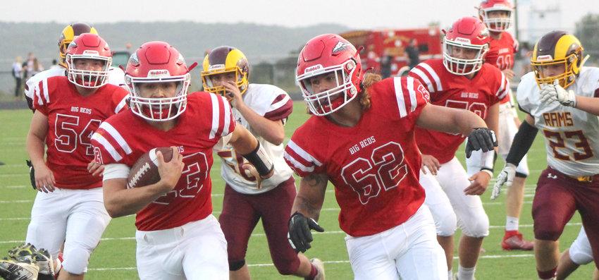 Missouri Valley's Eric McIlnay (23) carries the ball across the goal line for the Big Reds first touchdown in the Homecoming win over MVAOCOU on Sept. 18 in Missouri Valley. Big Reds lineman Jacob Meade (54) and Jace Coenen (62) cleared the path for the score.