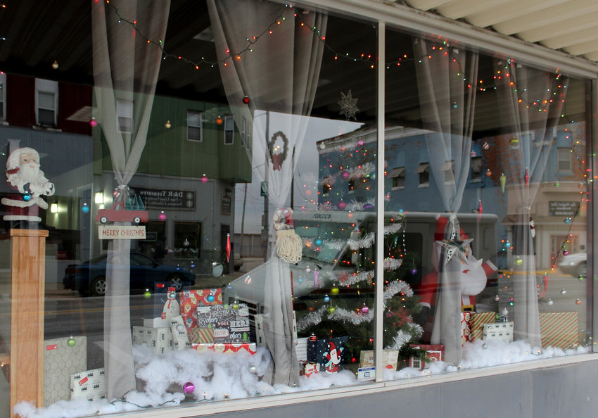 Soft and fluffy snow covers with floor of Integrated Therapy Resources' display window. A decorated Christmas tree, surrounded by festive decorations, brightly wrapped gifts, and an inflatable Santa round out the display. Lights are hung, and ornaments too, in the window, brightening Missouri Valley's main street and winning first place in the inaugural business decorating contest.