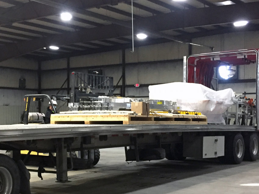 A forklift operator unloads equipment for the new Carry-On Trailers assembly line, located in the business's original Missouri Valley location.