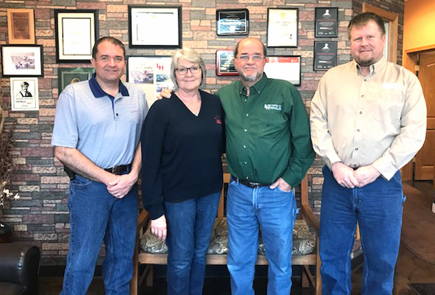 The Loftus family, from left, Nick, Becky and Kevin introduce the new owner of Loftus Heating, Inc., Jonathan Anderson, far right.