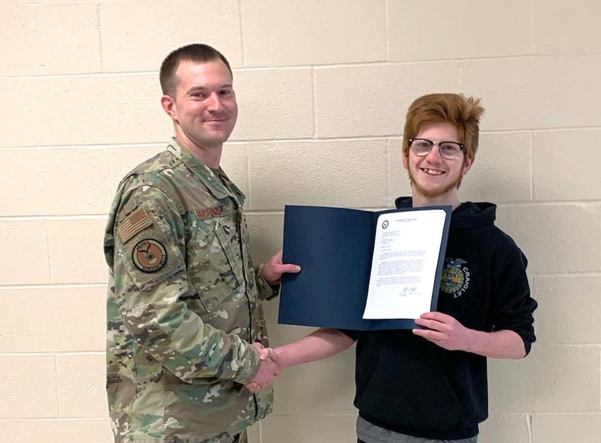 Chris Craig was awarded a letter presented by SSG Michael Buchanan, Air Force Recruiter from Sioux Falls before an assembly on April 21. Because of his commitment with the Air Force, he won&rsquo;t be at graduation commencement on May 23.