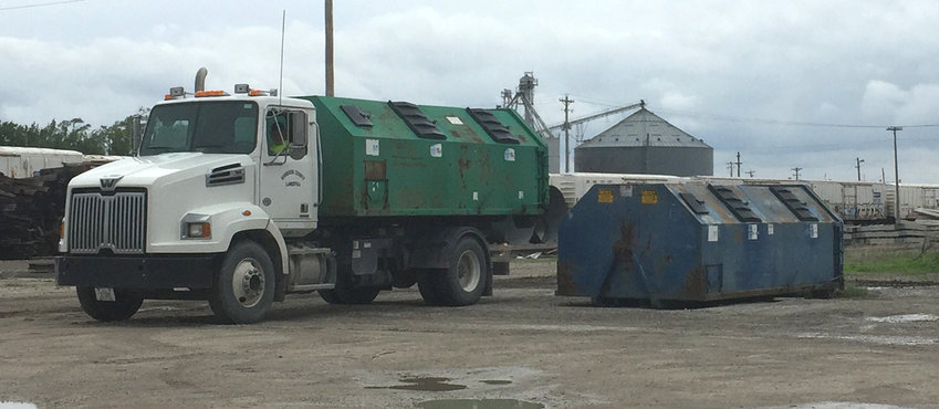 Harrison County residents are urged to ensure their recyclables are distributed securely into the proper containers to prevent litter now and later. Shown here a truck switches out recycling bins at the Missouri Valley location, west of the Rand Community Center.