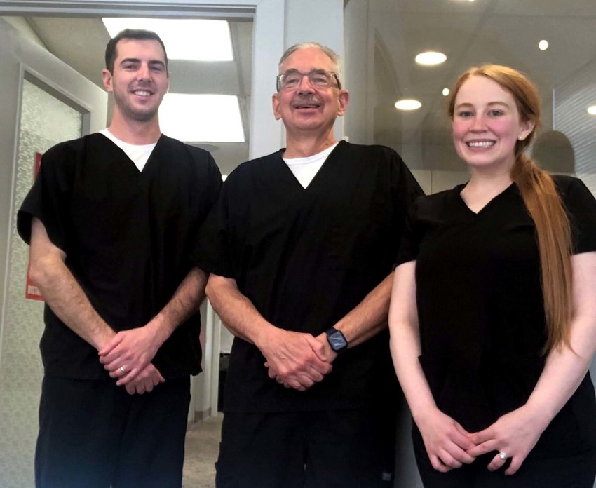 Dr. Jeffrey Walls, center, is beginning to scale back the hours he practices at Walls Family Dentistry. He announced that , in addition to his son, Dr. Alex Walls, left, Dr. Rebecca Anderson, right, has begun seeing patients at the Missouri Valley office.
