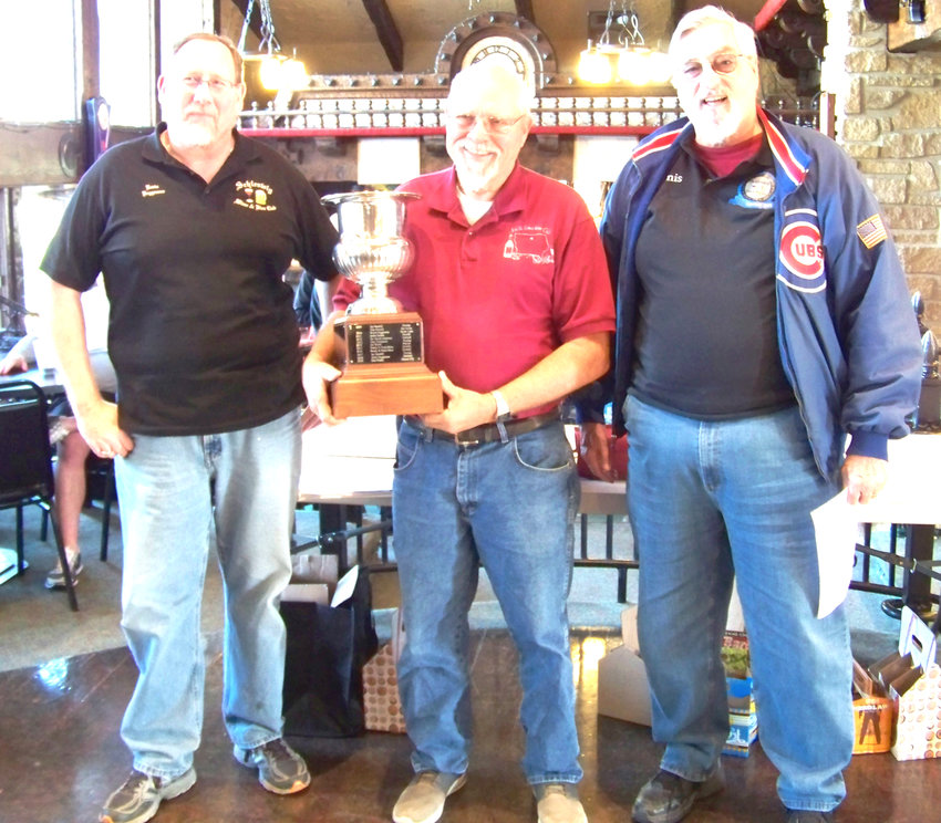 Club President Kevin Poggensee, left, from Wall Lake, Don Priebe with the traveling trophy and head wine judge, Dr. Dennis Crabb from Denison.