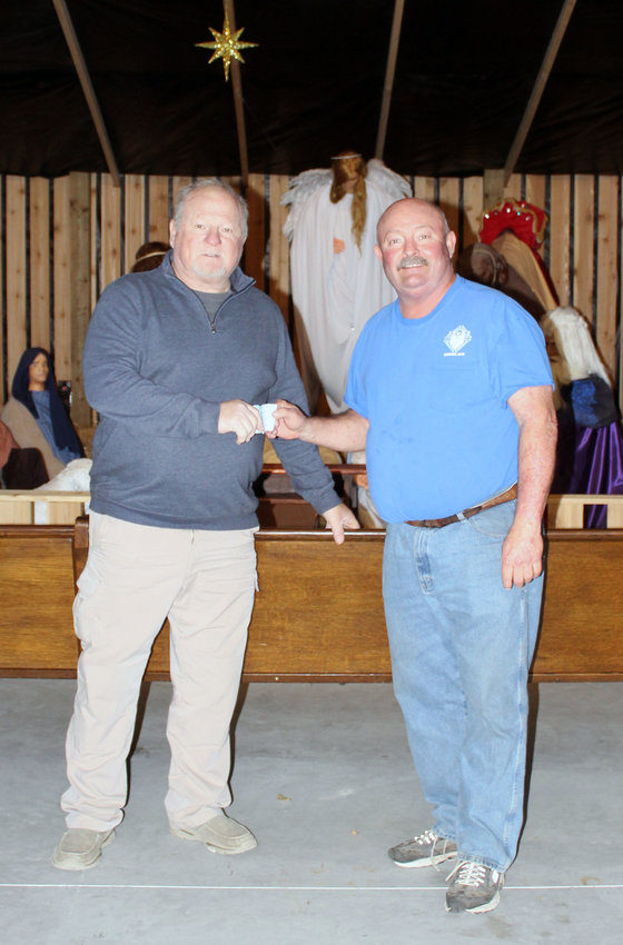 The Knights of Columbus Council 1249 of Dunlap presented a donation to the Dunlap Nativity on Friday, Nov. 19. Shown here are Silver Fox Foundation representative Ed Wendt, accepting the donation from Grand Knight Brian McGinn.