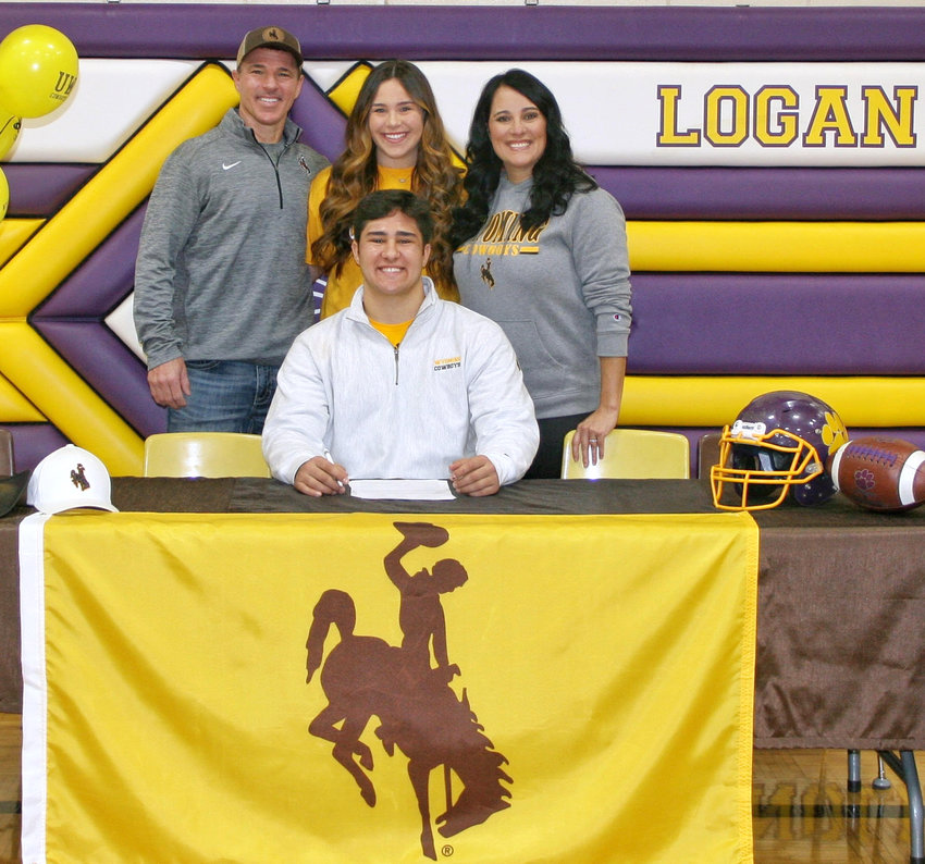 Logan-Magnolia senior Rex Johnsen (front, center), made it official, signing his National Letter of Intert on Dec. 17 to continue playing college football at the University of Wyoming starting in the fall of 2023.  The Panther offensive lineman has been a three-year start for the Panthers, as well as a two-year All-State offensive lineman. Standing in the back row includes his family, Lynn, Brooke and Sophia.