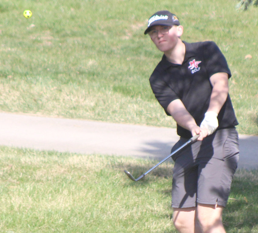 Missouri Valley's Evan White chips the ball onto the green in Western Iowa Conference play on April 21.