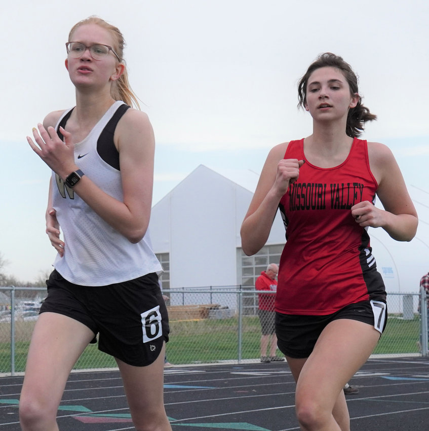 Woodbine's Kylee Cogdill and Missouri Valley's Bella Boruff battle during the 1500 m run at the Woodbine Invitational on April 28 in Woodbine.