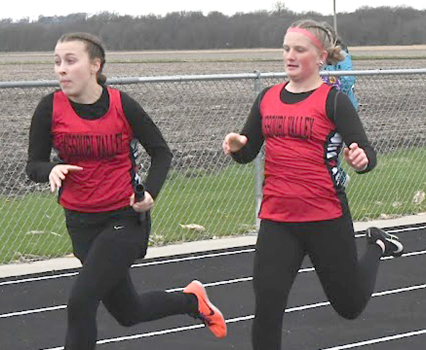 Missouri Valley's Crystal Martinez takes the baton from Brooklyn Lange in the Sprint Medley Relay at the Western Iowa Conference track meet in Avoca on May 3.