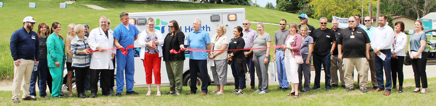 Representatives from CHI Health Missouri Valley, the Missouri Valley Chamber of Commerce, Midwest Medical, and Harrison County gathered for a ribbon cutting ceremony on Wednesday, June 1. The new transport vehicle can be seen in the background.