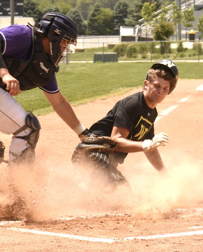 Woodbine's Cory Bantam slides in safely ahead of the tag in hte Tigers victory over OABCIG at the Tigers' home tournament on June 18.
