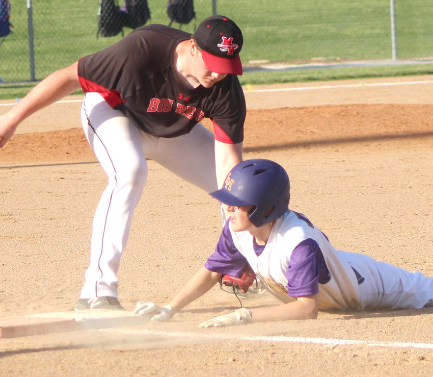 Logan-Magnolia's Lyrick Stueve slides in safely ahead of the tag by Missouri Valley's Kevin Wilson in the Western Iowa Conference battle at Logan on June 17.