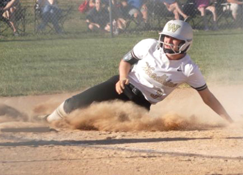 Woodbine's Nicole Sherer slides safely into third base in the regular season home finale against Treynor on June 28.