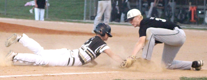 West Harrison's Koleson Evans tags out Woodbine's Austin Fitchhorn in the Class 1A District Final on July 9 at Woodbine.