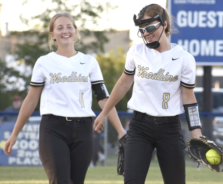 Woodbine's Nicole Hoefer (11) and Charlie Pryor (8) share a laugh in between innings at the Class 1A Regional Final on July 11 in Fonda.