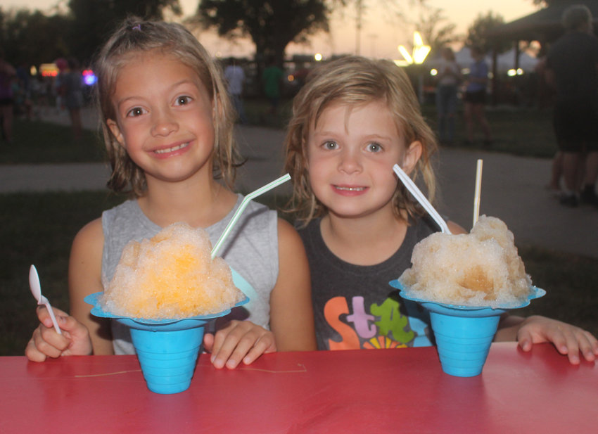 Eloise Ruma and Campbell Stevenson enjoy some sweet treats at the Harrison County Fair.