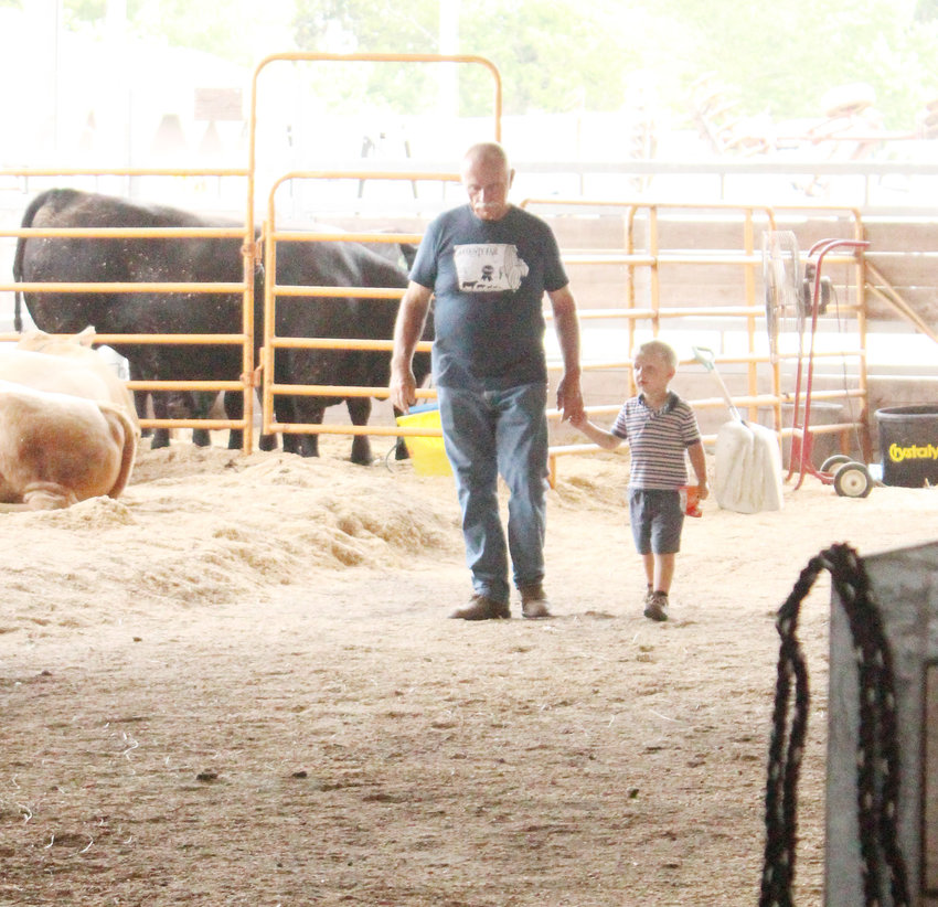 Gary Brock showing the next generation of youth the ropes of fair life.