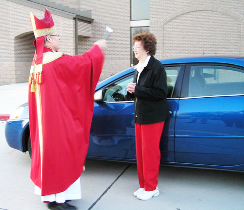 Bishop R. Walter Nickless of Sioux City Catholic Diocese blessing Estelle (Busch) Leinen of St. Mary, Dow City, and her new 2007 Pontiac G-7 in this file photo.