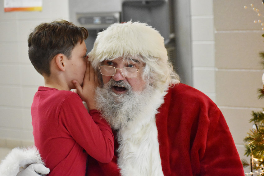 Santa was busy over the weekend making multiple stops in the county. One of his stops was in Mondamin for breakfast with Santa. Here Michael can be seen sharing a secret with the big man himself.