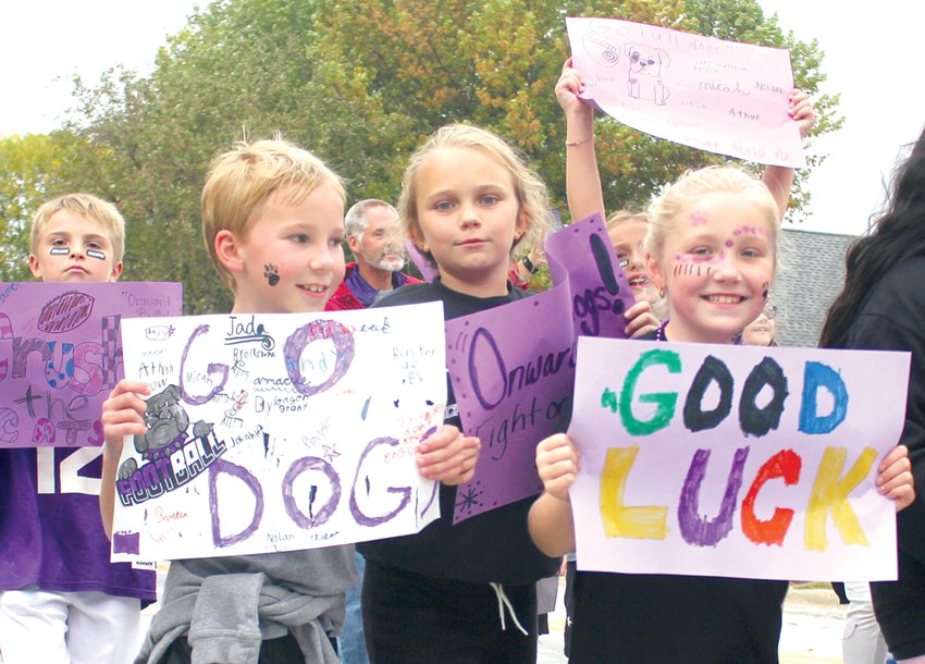 Children cheer on parade floats as they pass by during the Boyer Valley High School homecoming parade.