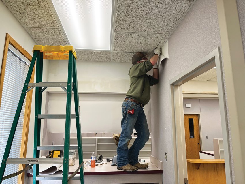 Johnny Tremel prepares the commercial space for its new occupants.