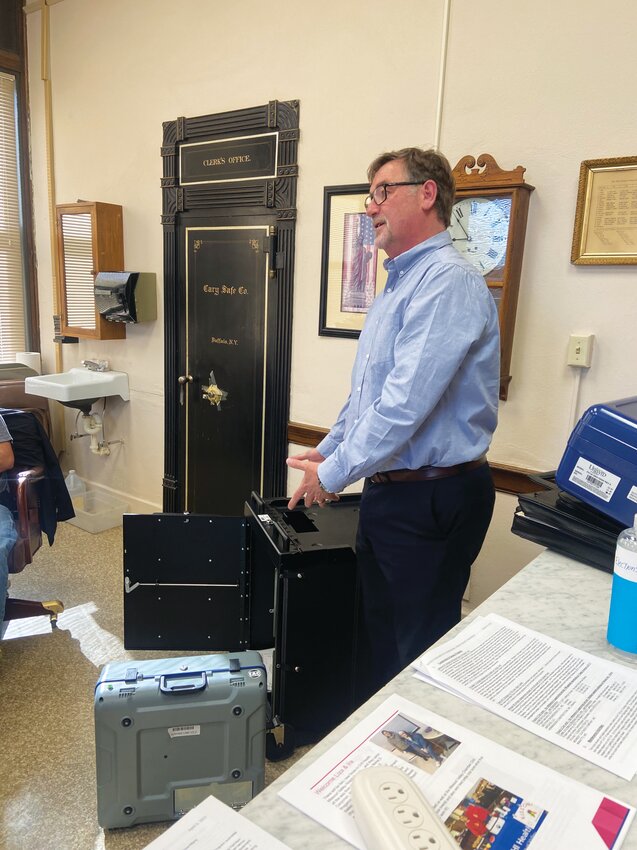 Mark Fredericks demonstrates how election equipment would be safely and securely stored away and transported.