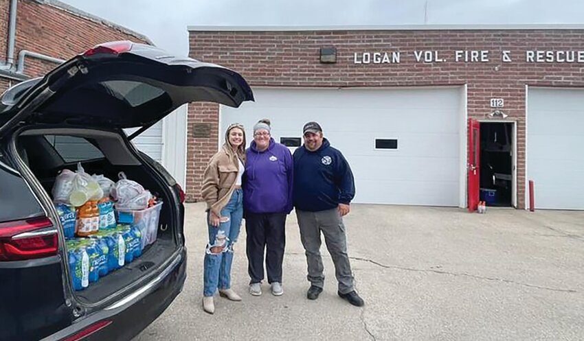 One of the community members that helped collect donations for local firemen was Ava Fischer. She can be seen here with Logan Fire and Rescue members Tina and Bill McElroy.