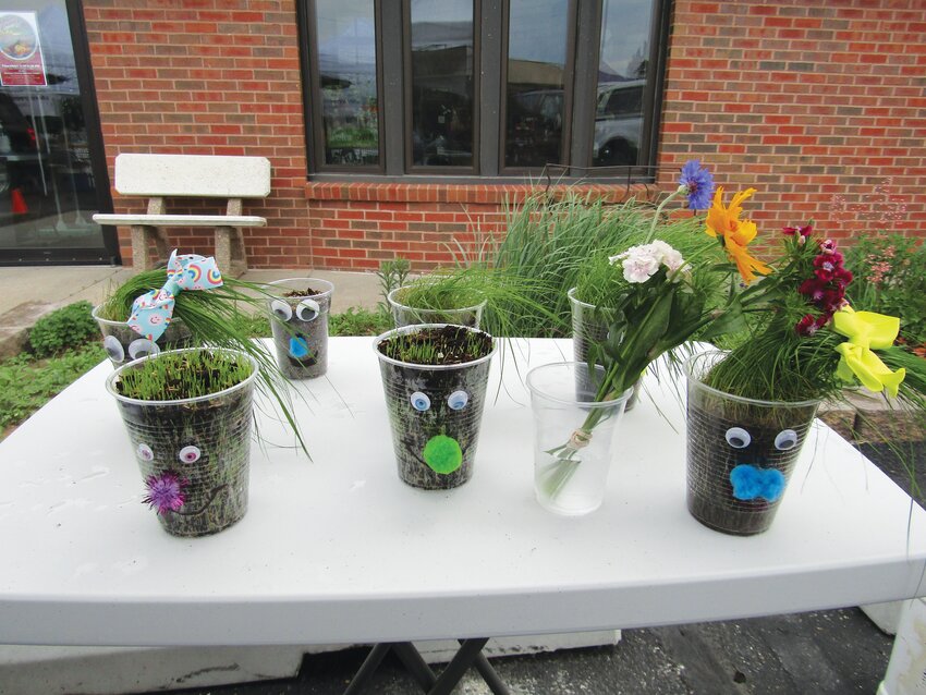 Kids had the opportunity to create their own &quot;grass babies&quot; at the Harrison County Welcome Center Farmers Market last Thursday.