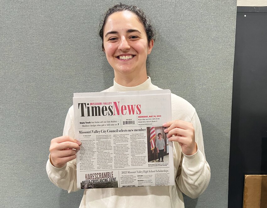 Isabelle Foland poses with the May 24 edition of the Times-News, with her story on new Missouri Valley city council member Marilyn Keizer above the fold.