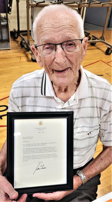 Glenn Cue, a 1941 graduate of Dow City-Arion, poses with his acknowledgement letter from President Joe Biden. Cue served in the U.S. Navy and recently celebrated his 100th birthday.