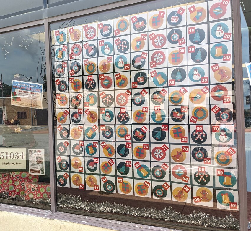 The Mapleton Press front window displays the &ldquo;Christmas in August Envelope Challenge.&rdquo; The money raised will go towards the purchase of new lights.