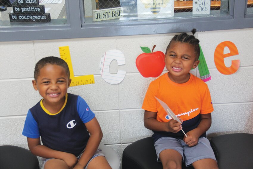 Braylin and Amarion Boyd crack a smile at West Harrison's open house last Monday.