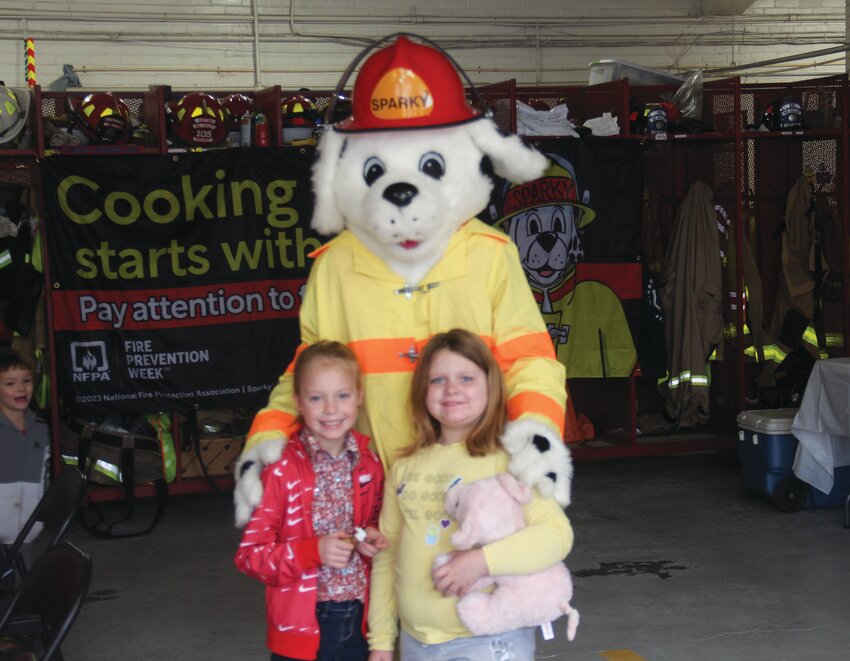 Kenzie Kobes and Lily Radloff took a picture with Sparky the Fire Dog at the Missouri Valley Fire Department's pancake feed on Saturday, Oct. 14.