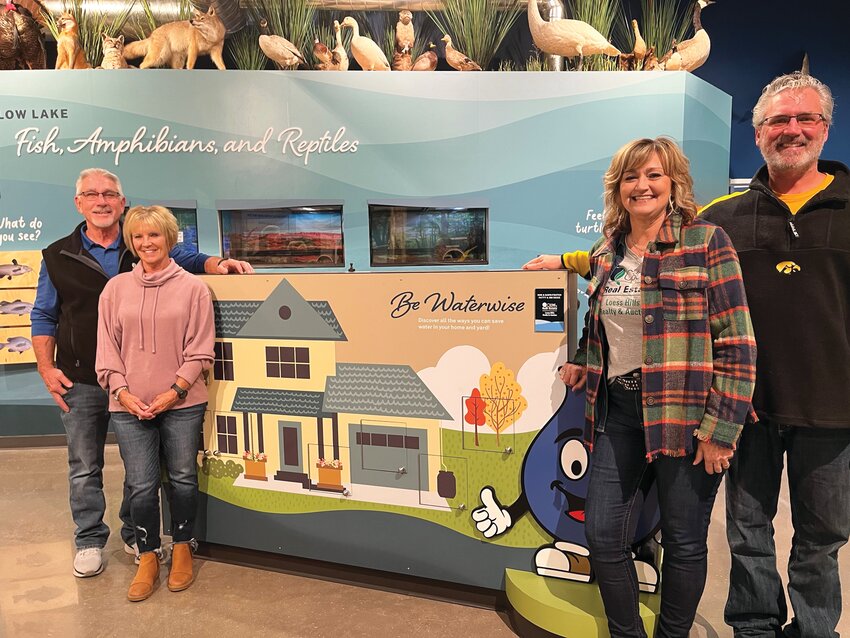 A Home and Yard exhibit shows how people can reduce water use and runoff of soil or chemicals. Pictured from left to right are exhibit sponsors, United Country Real Estate with Rod and Dawn Foutch and Patty and Jim Reisz.