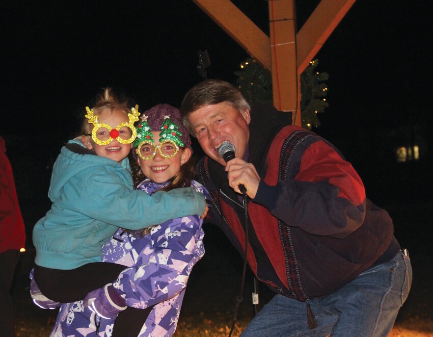 Lilly Jones and Kaylee Kurth got in the Christmas spirit by caroling with Rick Powell.