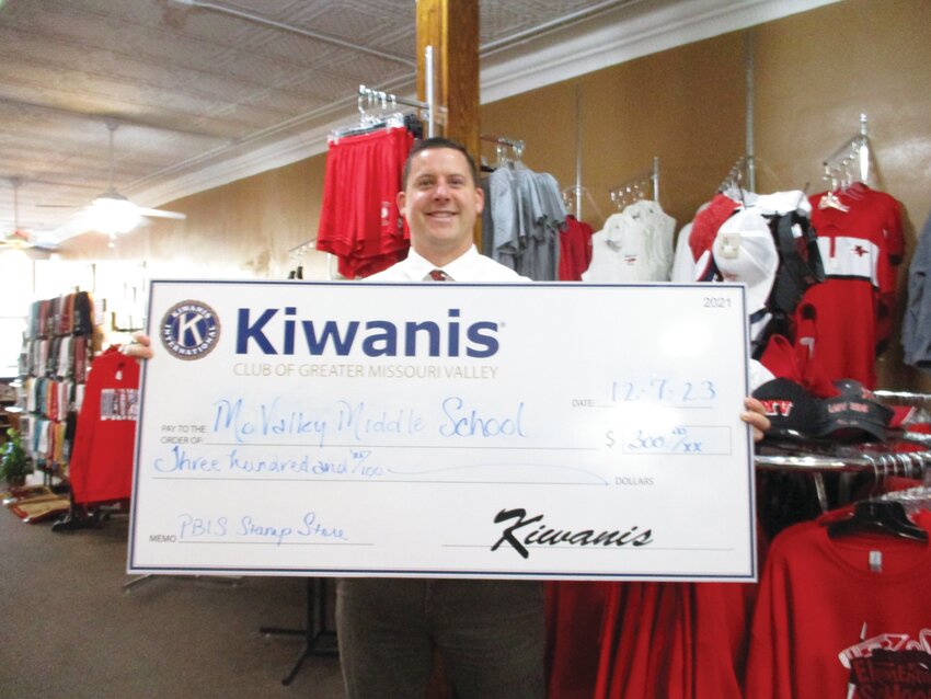 The Kiwanis Club presented $300 to the Missouri Valley Middle School's PBIS Stamp Store. Pictured is Principal Nate McDonald holding the check.