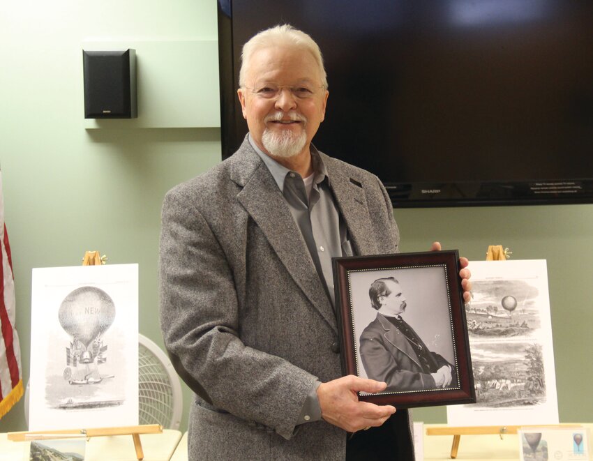 Terry Lowe holds a portrait of his great-great-grand uncle Thaddeus Lowe.