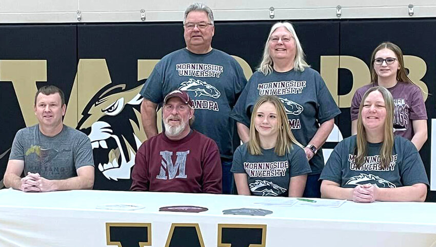 Woodbine Senior Kylie Neligh (front, second from right), signed her letter of intent to continue swimming at Morningside College (Sioux City). She is shown in the front row, from left: Rob Neligh, Coach Bryan Farris, Kylie Neligh, Bev Neligh.  Standing in the back, Bill Steppuhn, Barb Steppuhn, Kassidy Neligh.