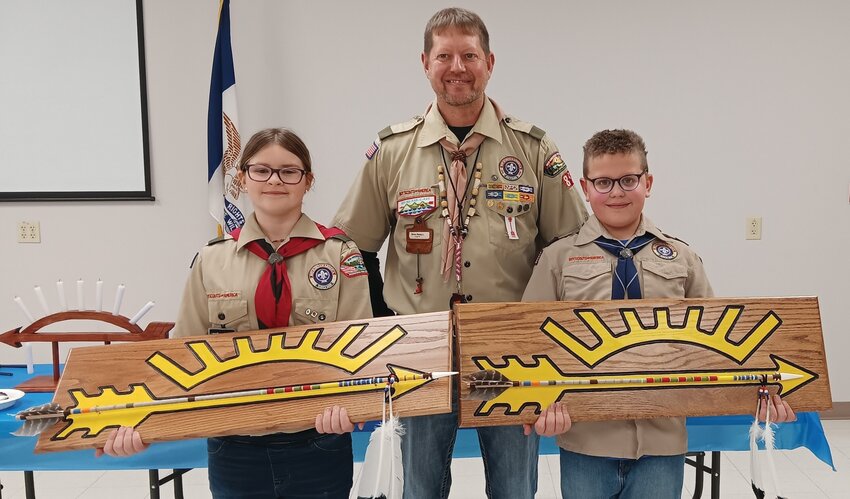 Cate Frazier (left) and Gabe Thacker (right) are pictured with Brian Nelson (middle) after receiving the Arrow of Light.