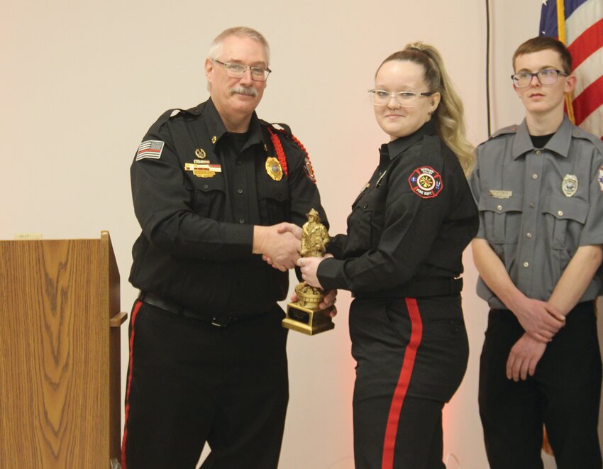 Chief Forest Dooley presents Haley Orr with the Firefighter of the Year award.