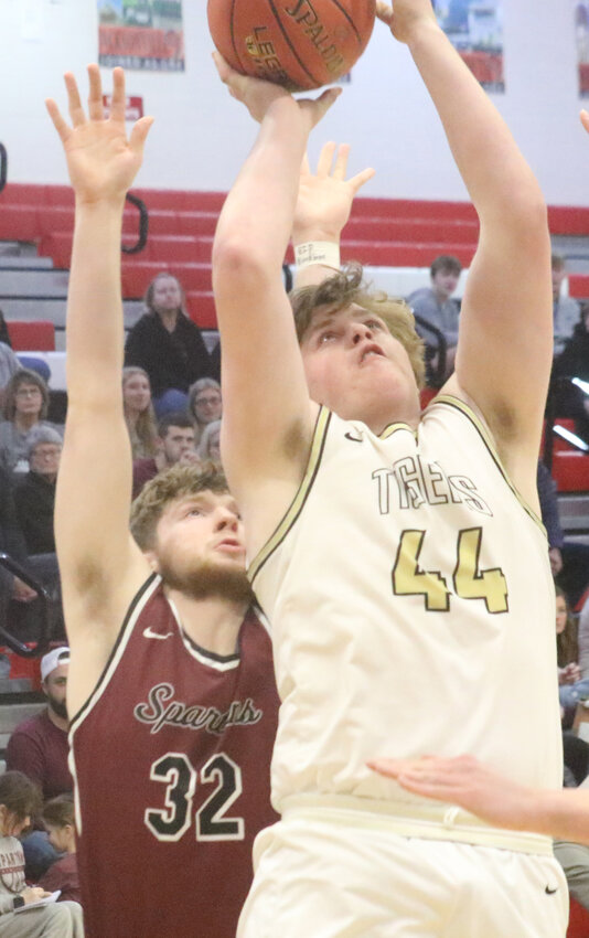 Woodbine's Jax Pryor powers his way up for a rebound in the Class 1A Substate Semifinal on Feb. 24 at Harlan.  He finished the night with an impressive 16 points, nine rebounds, and one steal.