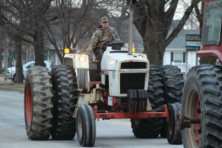 Pat Mumm drives his tractor down Iowa Avenue during Tractor Day in celebration of National Ag Day last year.