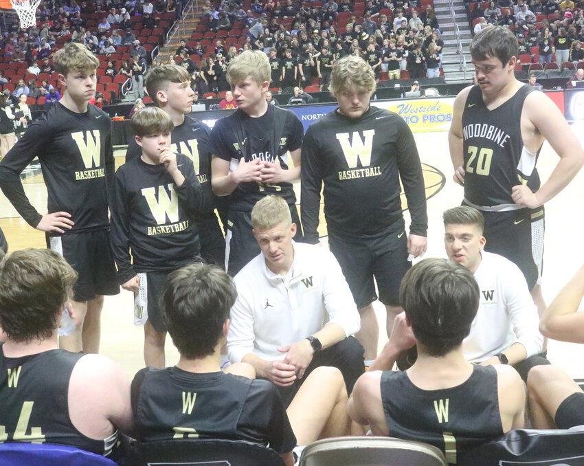 Woodbine's Coaching Staff, Kyle Bartels (left) and Greg Kolpin discus strategy during a time out at the Class 1A State Basketball championships on March 4 in Des Moines.