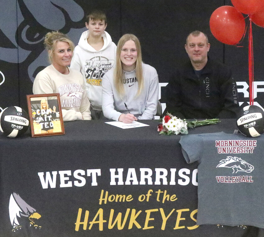 West Harrison senior standout Maclayn Houston (front, center) signed her letter of intent on Feb. 13 to continue playing volleyball at Morningside University (Sioux City) in the fall of 2024.  She is shown with her family Amy (Houston) Stoltz, Colt Stoltz, and Ryan Stoltz.  She plans on majoring in nursing.