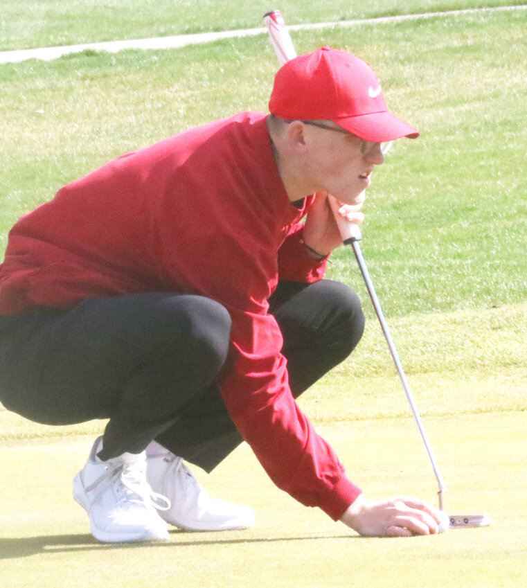 Missouri Valley's Evan White lines up a putt during Western Iowa Conference play on April 2 against Tri-Center.