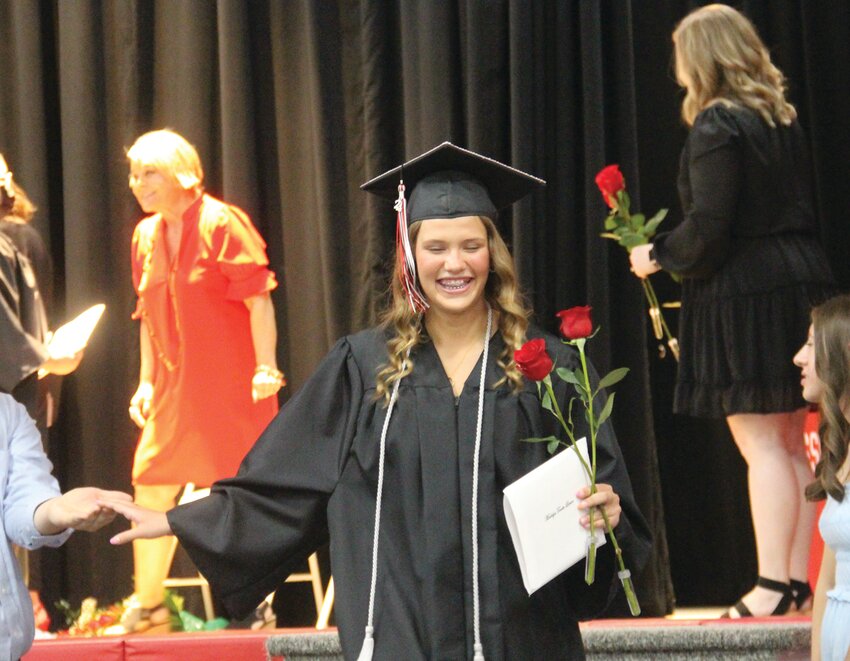 Madalyn Larson smiles while exiting the stage at Missouri Valley's graduation and commencement ceremony held on Saturday.